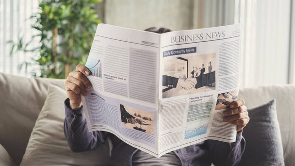 Senior man reading newspaper at home - Foto, immagini