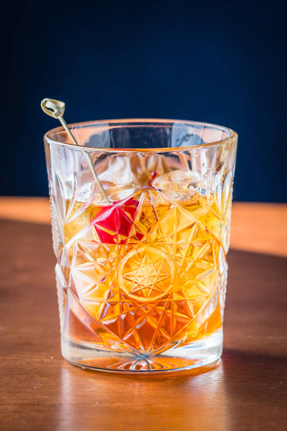 Old fashioned cocktail on a wooden table isolated on background - Fotografie, Obrázek