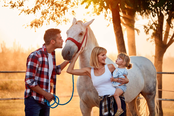 family  on the farm with beautiful horse  - Фото, зображення