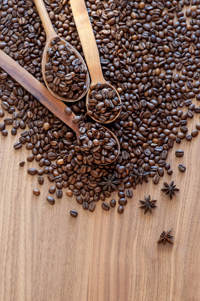 Coffee beans spilled on a wooden table - Photo, Image