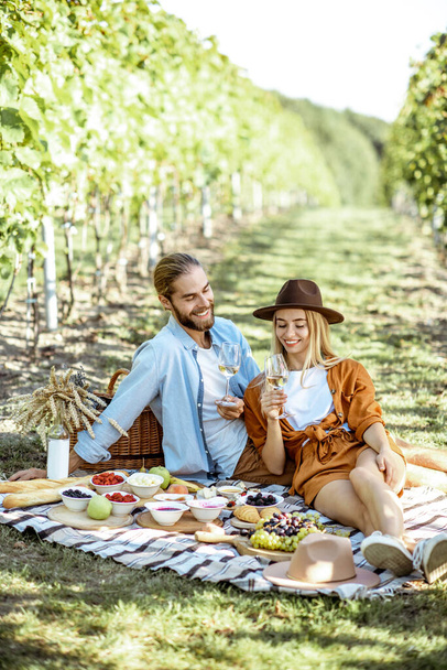 Young couple having a breakfast on the vineyard - Photo, image
