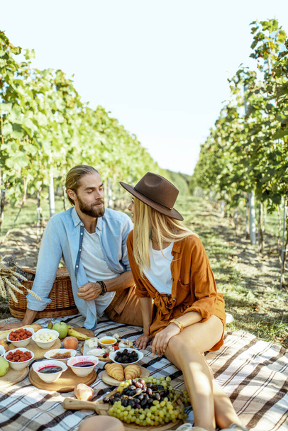 Young couple having a breakfast on the vineyard - Photo, Image