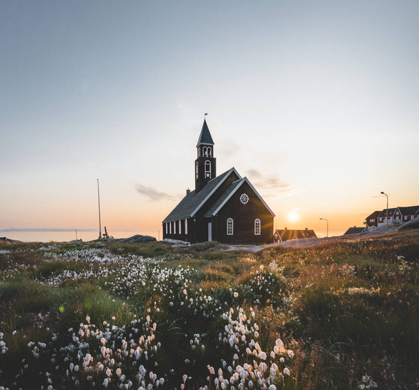 Old wodden Zions Church in arctic city of Ilulissat, with midnight sun light and blue sky in North Greenland - Zdjęcie, obraz
