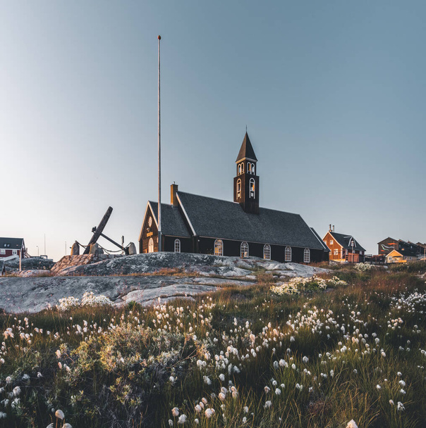 Old wodden Zions Church in arctic city of Ilulissat, with midnight sun light and blue sky in North Greenland - Fotografie, Obrázek