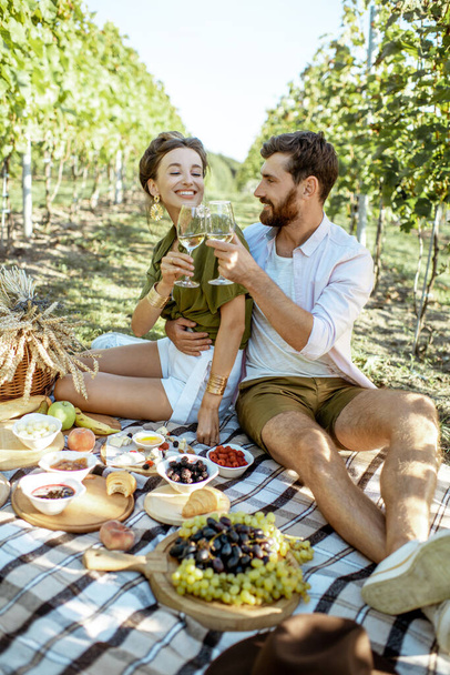 Young couple having a breakfast on the vineyard - 写真・画像