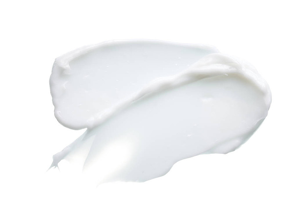 White texture and smear of face cream or white acrylic paint isolated on white background - Foto, afbeelding