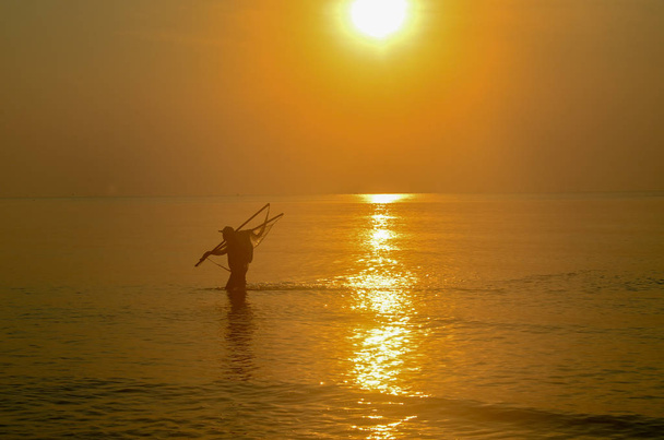 Net Fisherman ocean wading with tropical sunrise seascape , Thai - Photo, Image