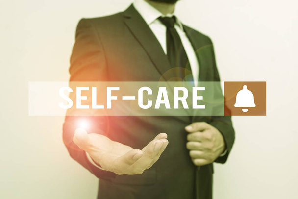 Word writing text Self Care. Business concept for practice of taking action to preserve or improve ones own health Male human with beard wear formal working suit clothes raising one hand up. - Photo, Image