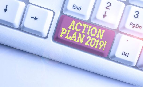 Text sign showing Action Plan 2019. Conceptual photo proposed strategy or course of actions for current year White pc keyboard with empty note paper above white background key copy space. - Photo, Image