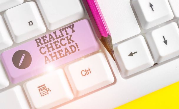 Text sign showing Reality Check Ahead. Conceptual photo makes them recognize truth about situations or difficulties White pc keyboard with empty note paper above white background key copy space. - Photo, Image