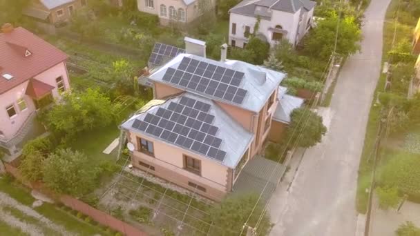 Aerial view of a private house with solar panels on roof. Photo voltaic system for renewable energy on building and on the ground. - Footage, Video
