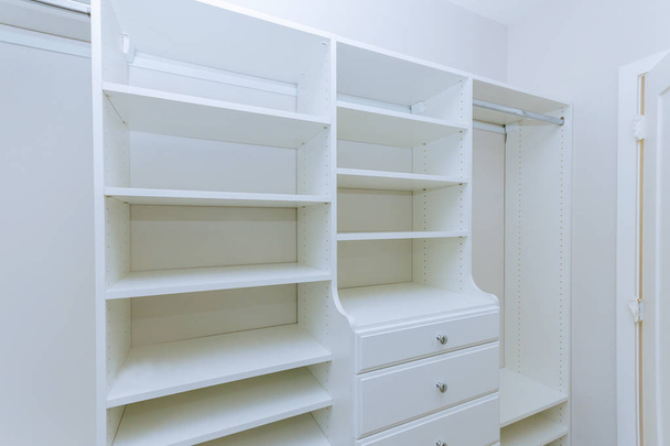 Installation shelves with interior of white plastic cabinet or clothing with many empty - Photo, Image