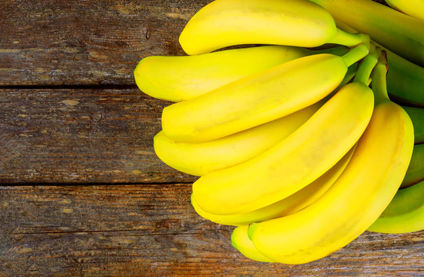 Fresh yellow bananas on wooden table - Photo, Image