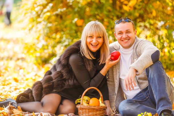 romantic young couple have picnic in city park at autumn season - Fotó, kép
