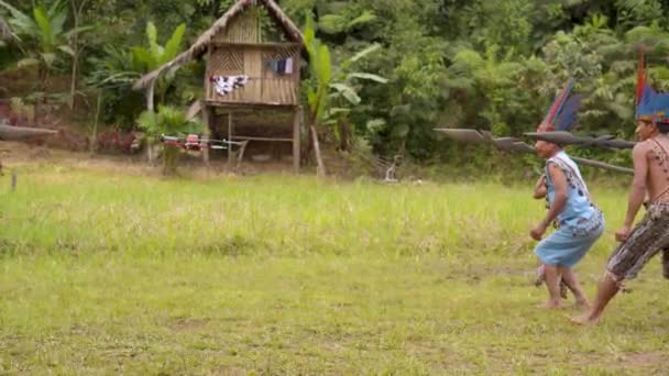 Een groep inheemse mensen vallen een drone met speren aan - Video