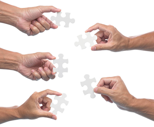 Man hand holding jigsaw puzzle isolated on white background - 写真・画像
