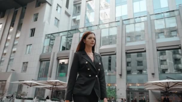 Young adult businesswoman walking near business center - Footage, Video