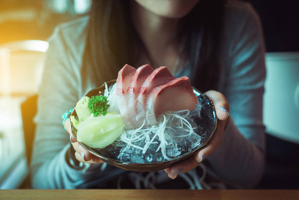 Closeup of hand woman holding Tuna Hamachi set,Japanese food in traditional Japan - Foto, Imagem