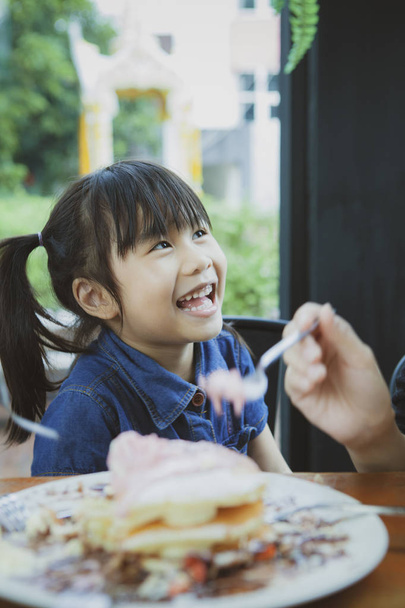 happiness face of asian children with sweet dessert on table for - Photo, Image