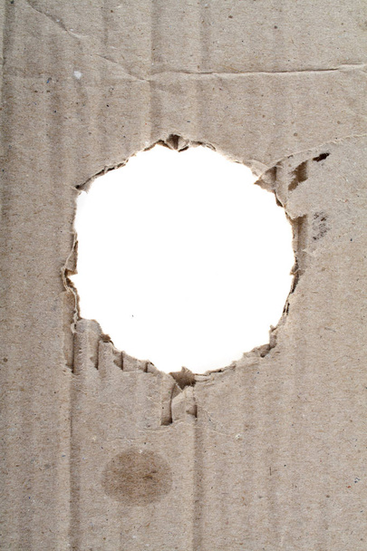paper with a hole isolated on a black background - Photo, image