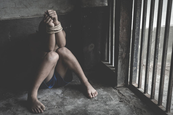 hopeloos kind handen en voeten gebonden samen met touw, mensenhandel, - Foto, afbeelding