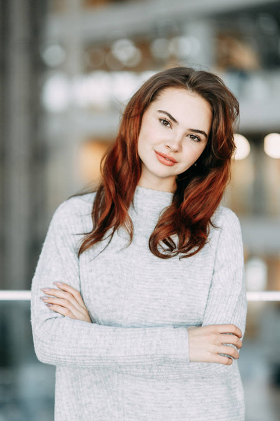 Bright emotions, smile and burning eyes of the model. Portrait of a beautiful girl in the business center.  - Valokuva, kuva