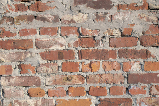 Rough brickwork as a background in sunlight - Fotó, kép