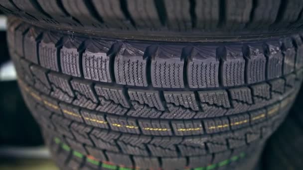 Many new winter tires on shelves and in columns. Panorama of the store - Footage, Video