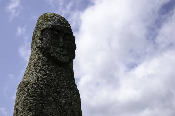 Face of the 8th century stone idol against a blue sky, Arkhyz, Karachay-Cherkessia, Russia - Fotografie, Obrázek