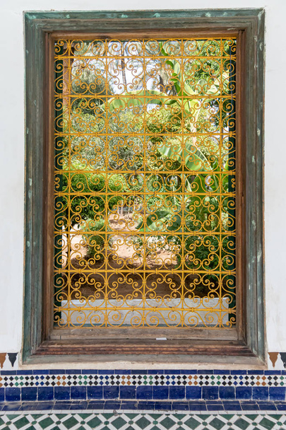 Detail of yellow decorative fence of a window of the Bahia palace in Marrakech. Morocco - Photo, Image