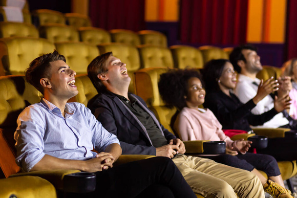 Male friends watching comedy movie in cinema - Photo, Image