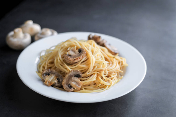 Pasta with mushrooms on a black background. Copy space for your text - Foto, immagini