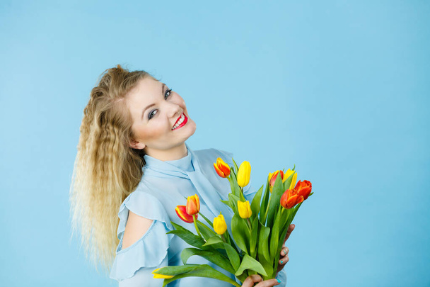 Pretty woman with red yellow tulips bunch - Фото, изображение