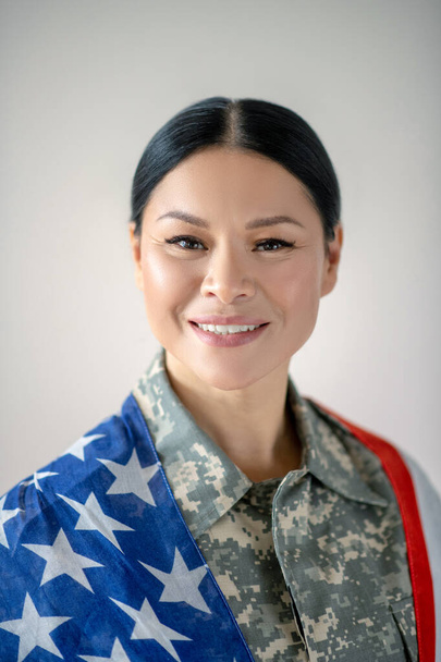 Excited Asian military woman smiling while feeling excited - Foto, Imagem