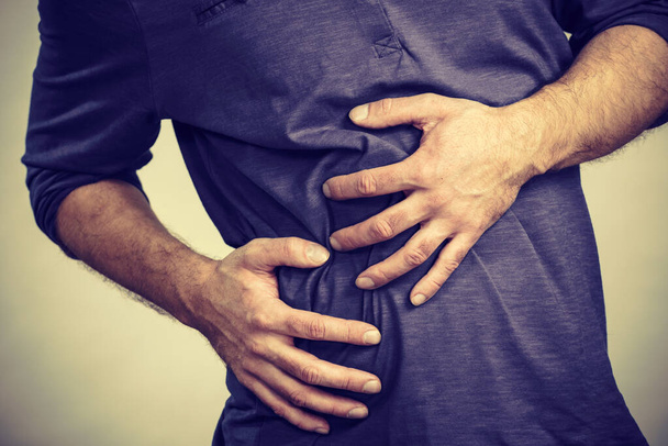 Man feeling stomach ache pain - Фото, изображение