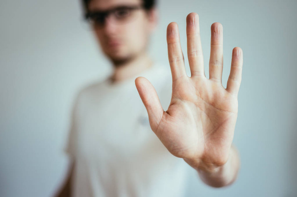 Defense or stop gesture: Male hand with stop gesture - Foto, Bild