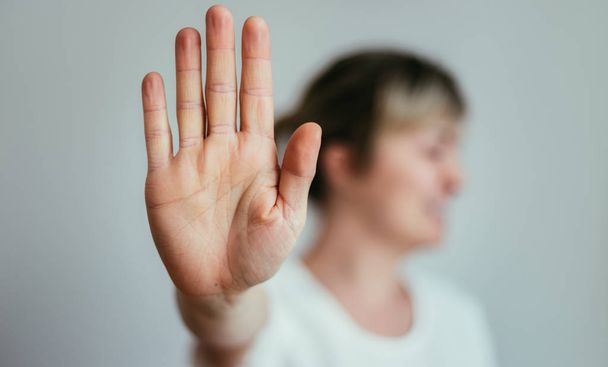 Defense or stop gesture: Girl hand with stop gesture - Photo, image