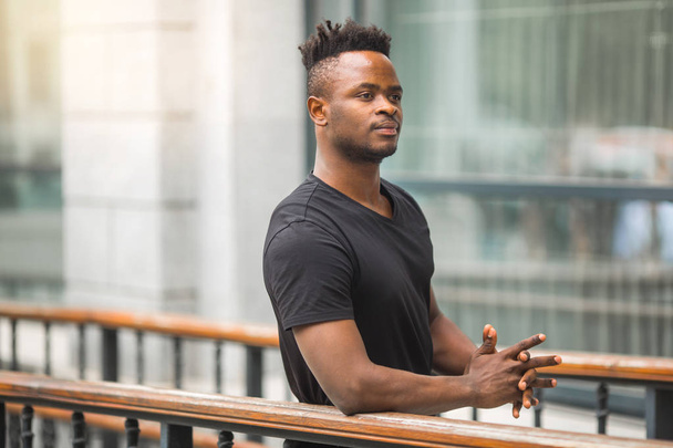 handsome young african man in black t-shirt - Foto, afbeelding