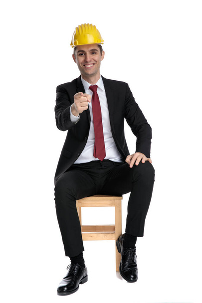 Cheerful businessman pointing forward while wearing a constructi - Photo, Image