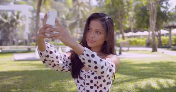 Smiling Asian woman taking selfie on smartphone with smile - Materiał filmowy, wideo