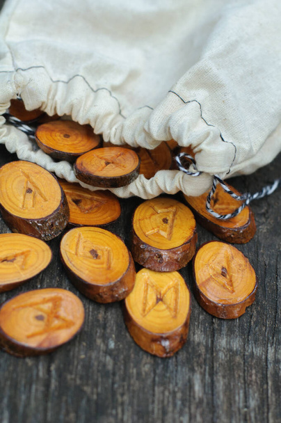 wooden runes poured from a white pouch - Photo, Image