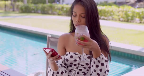 Joyful ethnic young woman interacting with smartphone at poolside - Metraje, vídeo