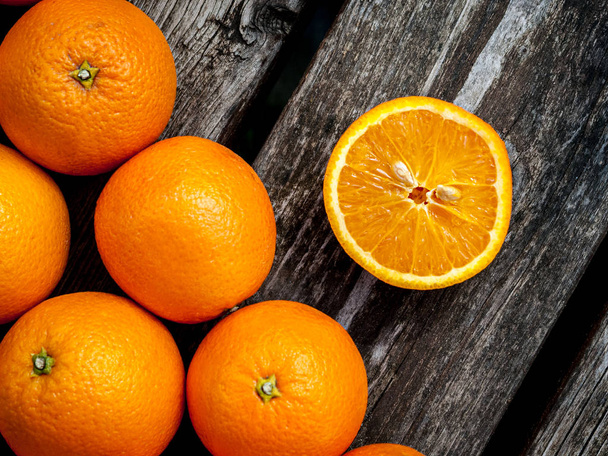 Fresh juicy oranges on a wooden table - 写真・画像