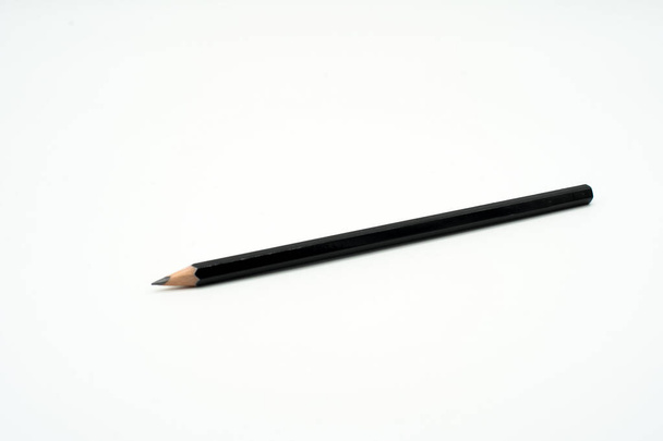 Black wooden pencil isolated on white background - Photo, Image
