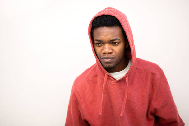 Portrait young african american man with hoodie and serious expression on face by white background - Foto, immagini
