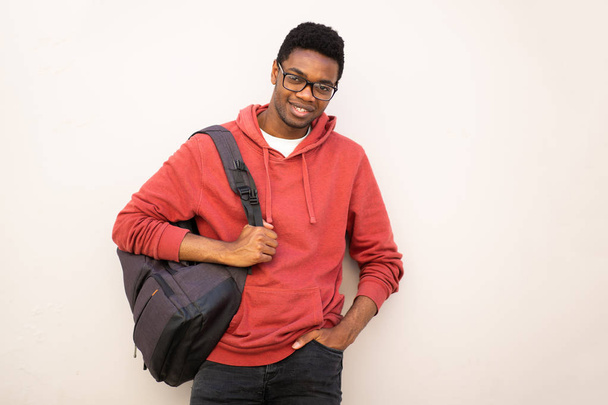 Muotokuva nuori afrikkalainen amerikkalainen mies lasit ja laukku valkoista taustaa vasten
  - Valokuva, kuva