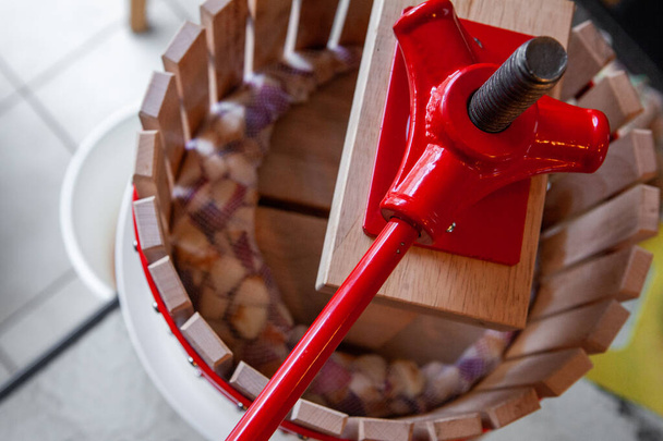 Pressing apple juice with a small apple press, before making cider with it - Photo, Image