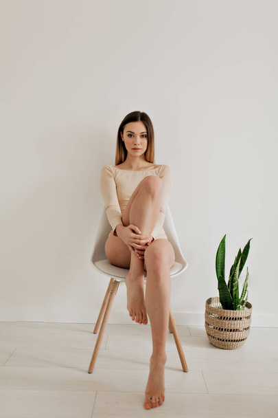 Full-Length portrait of attractive pretty european woman wearing beige body  posing at camera - Photo, image