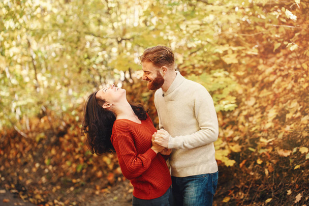 Portret van een mooie vrouw die verliefd is op een stel. Vriend en vriendin knuffelen wandelen buiten in het park op herfstdag. Samenzijn en geluk. Authentieke gevoelens van echte mensen. - Foto, afbeelding