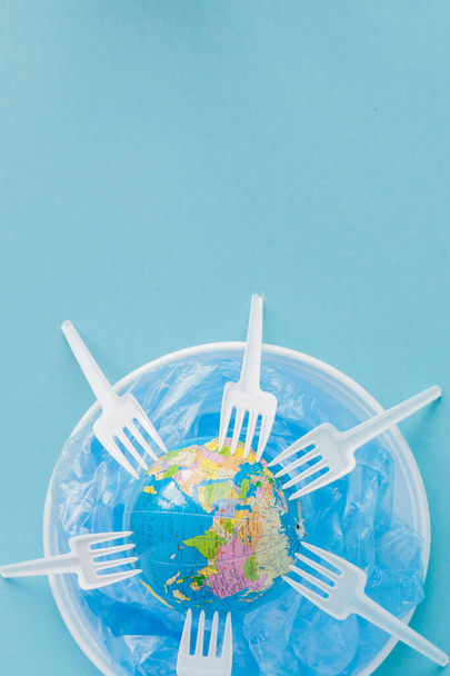 Globe on a plastic plate. The concept of ecology, land conservat - Foto, Bild